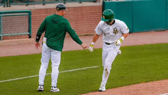 Brady Janusek rounds third after hitting a home run against BYU in 2026