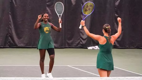 Kennedy Gibbs celebrates doubles point in the Hawkins Indoor over Utah