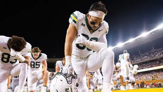 Michael Allen kneeling for pregame prayer 2025