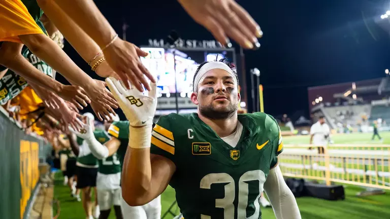 Michael Allen high-fiving fans after beating PVAMU 2026