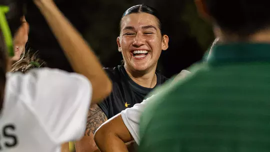 Azul Alvarez smiles and laughs while surrounded by teammates in celebration after Baylor soccer's win over Pepperdine.