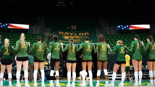 Baylor Volleyball Poses for the national Anthem before a match against UNT