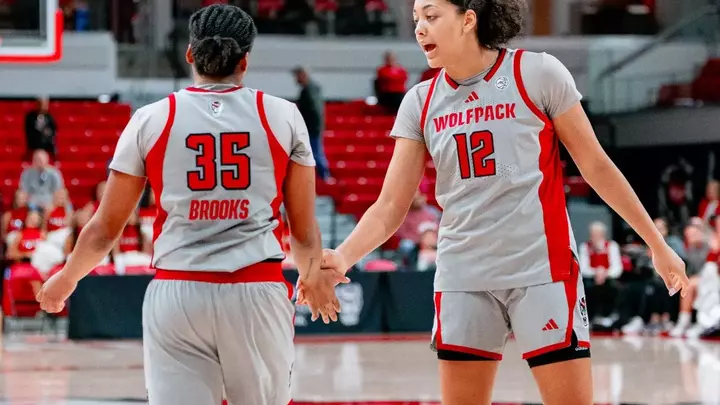 Khamil Pierre and Zoe Brooks high five during game