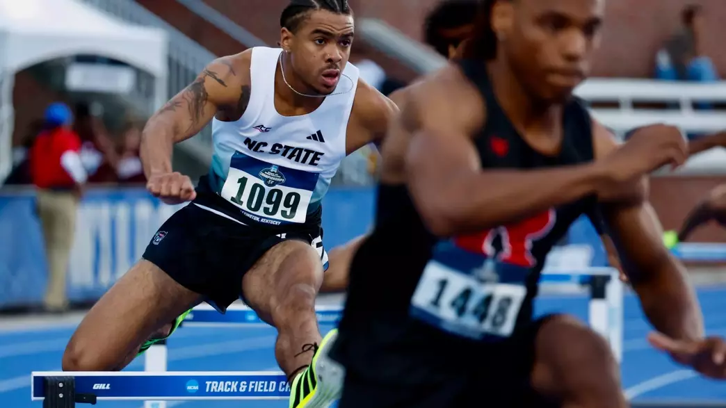 Xavier Branker jumping over a hurdle in the first round of the 400m hurdles at the NCAA East First Round