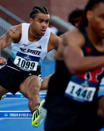 Xavier Branker jumping over a hurdle in the first round of the 400m hurdles at the NCAA East First Round