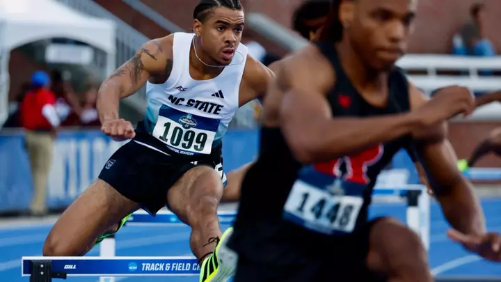 Xavier Branker jumping over a hurdle in the first round of the 400m hurdles at the NCAA East First Round
