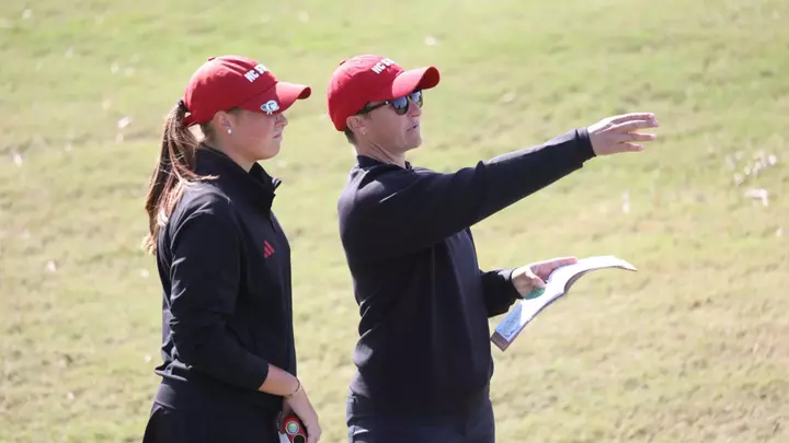 Courtney Gunter coaches Ellie Hildreth through a hole at a golf tournament