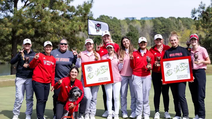 NC State women's golf team poses after a win