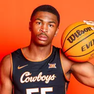 Jacob Walker wearing a black OSU jersey poses with a basketball against an orange backdrop