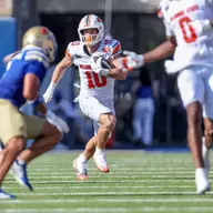 Oklahoma State wide receiver Wyatt Young eludes a tackler from Tulsa