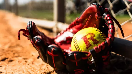 Rutgers Block R softball in glove on dirt - general