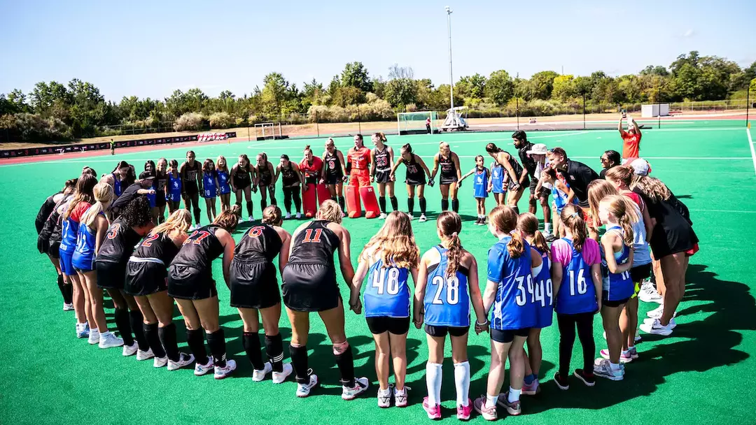 Field Hockey Huddles With Youths
