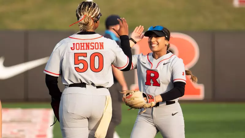 Rachel Millan high fives Dezaria Johnson during the Wagner game at the RU Softball Complex