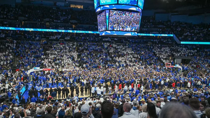 Dec 4, 2024; Omaha, Nebraska, USA; Fans of the Creighton Bluejays rush the court after the win against the Kansas Jayhawks during the second half at CHI Health Center Omaha. Mandatory Credit: Steven Branscombe-Imagn Images