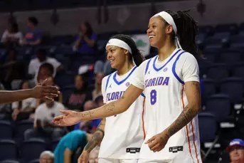 Me'Arah O'Neal and Jade Weatherspoon smiling after a made basket and a foul vs. Furman
