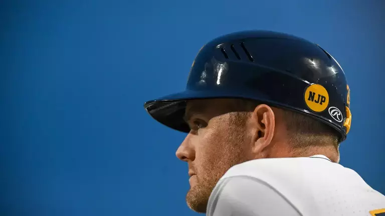 Steve Sabins watches from the dugout.