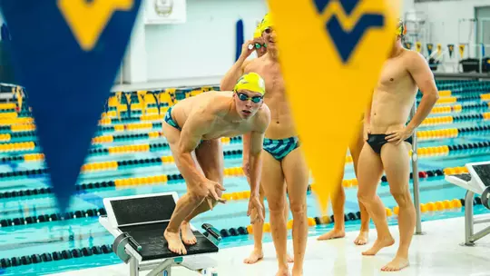 Parker Sterlitz prepares to dive into the water from the starting block.
