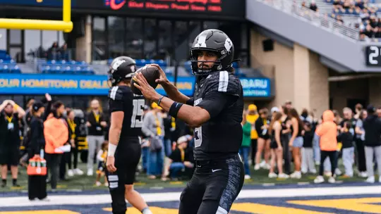 West Virginia players warm up prior to their game against Arizona at Milan Puskar Stadium in Morgantown, W.Va., on Oct. 10, 2026.
