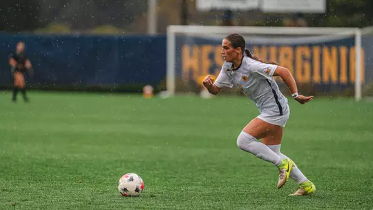 Olivia Shertzer dribbles the ball during a game at Dick Dlesk Soccer Stadium.