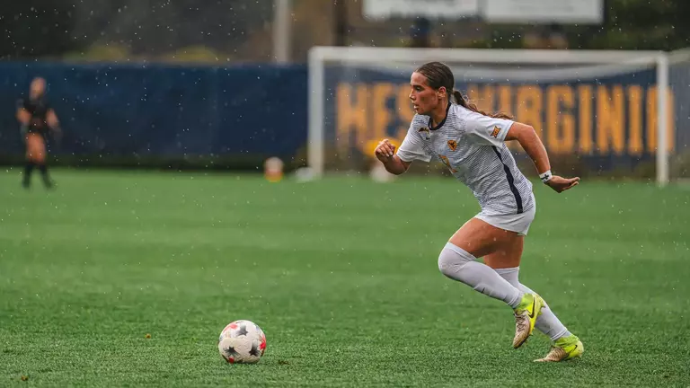 Olivia Shertzer dribbles the ball during a game at Dick Dlesk Soccer Stadium.