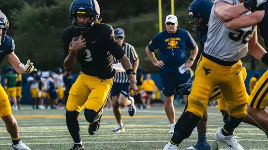 Quarterback Michael Hawkins Jr. runs the football during practice on the Steve Antoline Family Practice Facility on Tuesday, October. 13, as West Virginia prepares to face Cincinnati on Saturday in Milan Puskar Stadium.