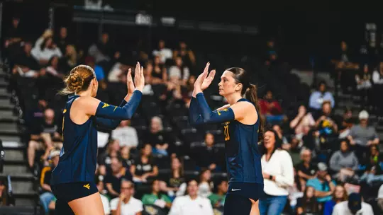 Macie Smith and Alexis Finnvold high five when playing against UCF on Oct. 18