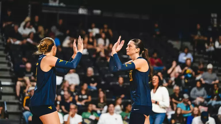Macie Smith and Alexis Finnvold high five when playing against UCF on Oct. 18