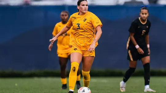 Jacey Rase dribbles a ball during a match at Dick Dlesk Soccer Stadium.