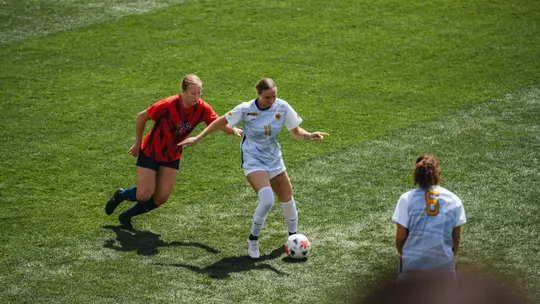 Jordyn Wilson dribbles a ball past a defender at Dick Dlesk Soccer Stadium.