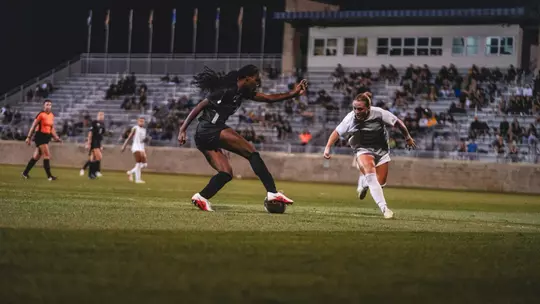Tyler Clyburn dribbles a ball during a match at Dick Dlesk Soccer Stadium.