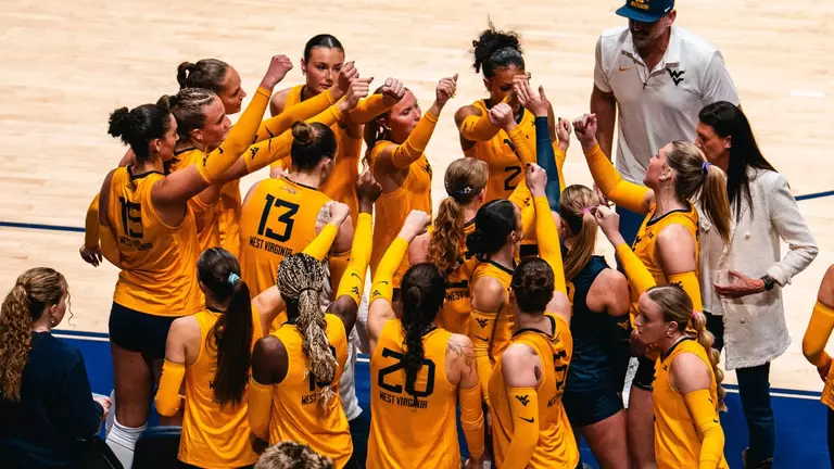WVU Volleyball team huddles before going back out to play Houston on Oct. 4