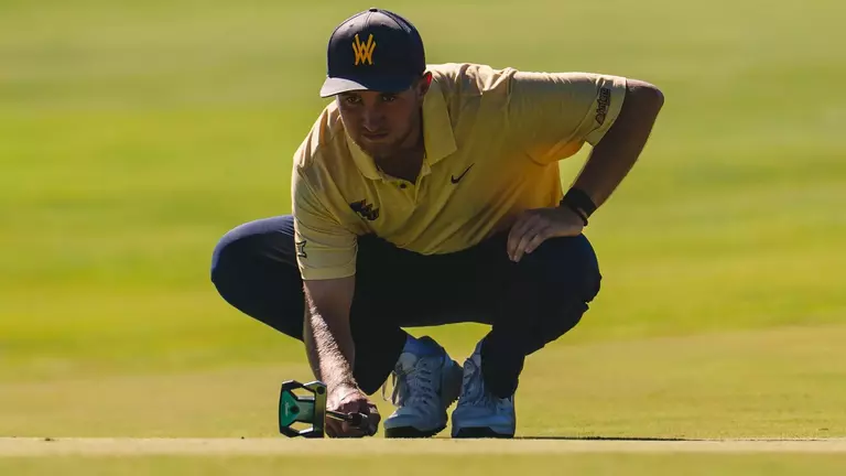 Jack Michael lines up a putt at Nemacollin