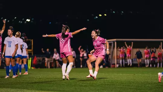 Sophia Nickel and Maya Leoni celebrate after a goal.