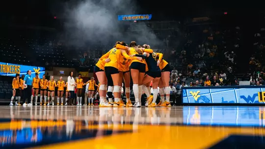 WVU huddles before the match against Houston on Oct. 4 inside Hope Coliseum