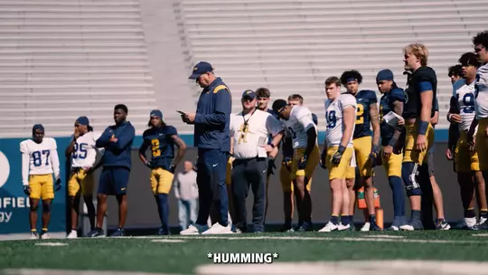West Virginia head football coach Rich Rodriguez is mic'd up for a practice.
