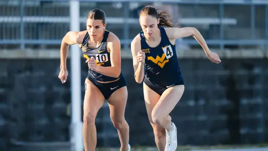 Aislinn Frazer and Eva Rinker prepare to start the 800 meters at the WVU Last Chance Meet