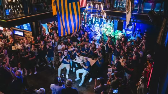 The West Virginia University baseball team watches its name come up on the board for the 2026 NCAA Tournament during its team watch party at The Goat Country Roads Pub in Morgantown, West Virginia, on Monday, May 25, 2026.