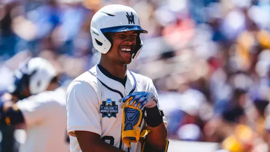 Tyrus Hall smiles during the West Virginia baseball game against Troy in the Men's College World Series