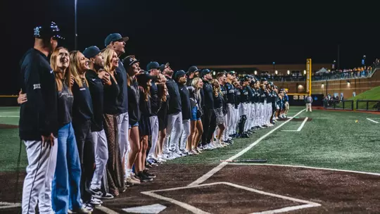 West Virginia University baseball players, coaches and staffers sing Take Me Home, Country Roads following the Mountaineers' come-from-behind, 10th inning victory over Kentucky at Kendrick Family Ballpark on Monday, June 1, 2026.