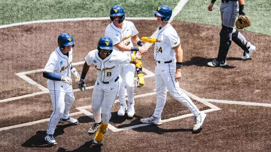 Tyrus Hall celebrates after hitting a grand slam against Cal Poly in game one of the NCAA Super Regionals