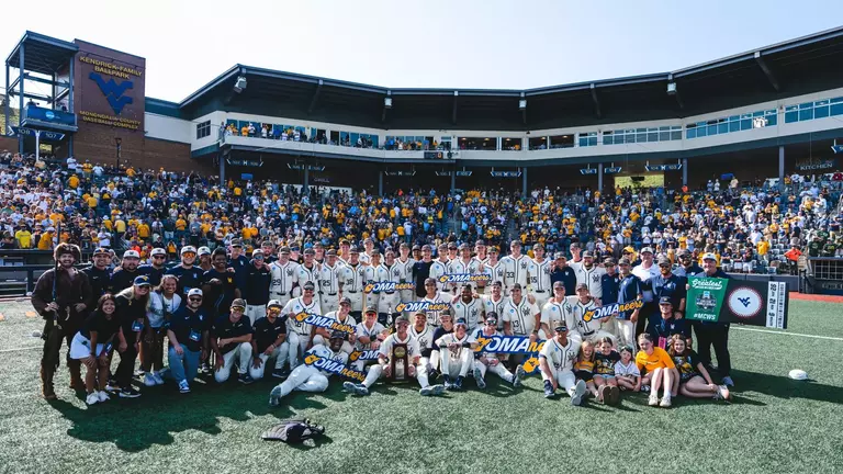 The West Virginia Baseball team poses for a photo after winning the NCAA Morgantown Super Regional