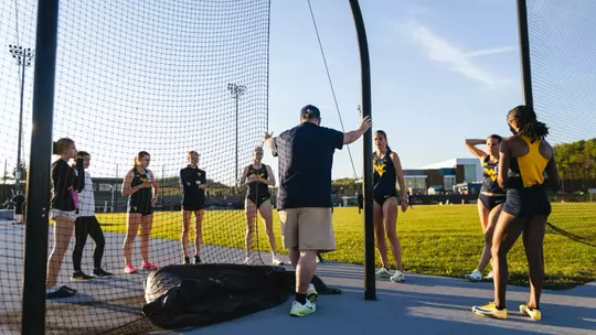 Head Coach Sean Cleary talks with the Track and Field team before a meet