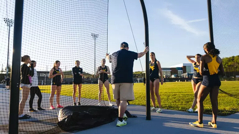 Head Coach Sean Cleary talks with the Track and Field team before a meet