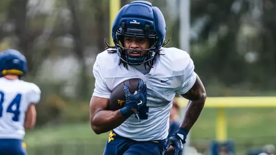 West Virginia running back Cam Cook performs a drill during spring football practice at the Steve Antoline Family Practice Field in Morgantown, W.Va.