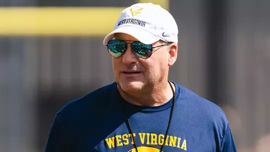 West Virginia coach Rich Rodriguez talks to his team after an August morning workout on the Steve Antoline Family Practice Facility in Morgantown, West Virginia.