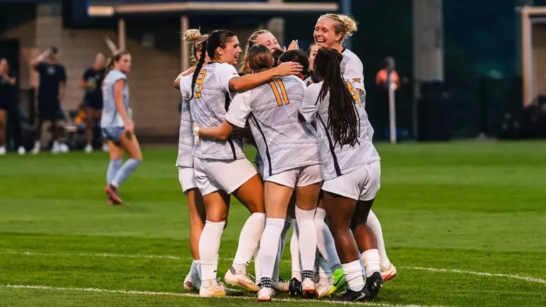 Members of the WVU women's soccer team celebrate after a goal on Aug. 13, 2026.