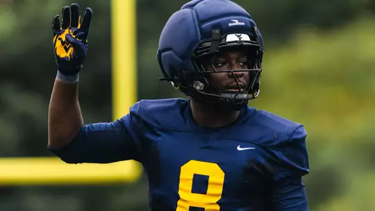 West Virginia senior safety Kamari Wilson calls out a defense during a summer practice at the Steve Antoline Family Practice Field .
