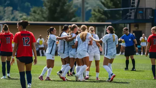 WVU women's soccer players celebrate a goal against Duquesne on Aug. 23.