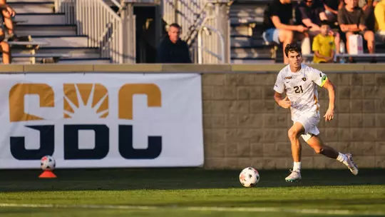 Isaac Scheer dribbles the ball against St. Bonaventure
