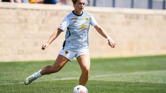 Alina Gnädig prepares to pass a ball during a game at Dick Dlesk Soccer Stadium.